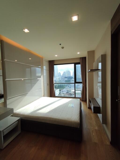 Spacious bedroom with large windows and modern furnishings