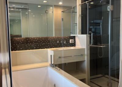 Modern bathroom with bathtub and glass shower enclosure