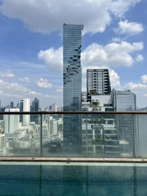 View of city skyline with tall buildings from a rooftop