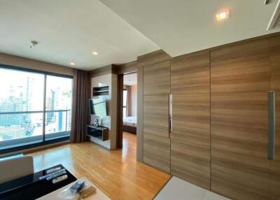 Modern apartment living room with wooden paneling and large window