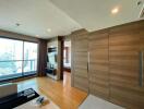 Modern apartment living room with wooden paneling and large window