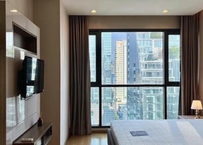 Modern bedroom with large windows and city view