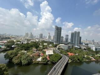 Aerial view of a city with skyscrapers, roads, and greenery