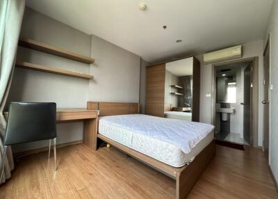 Modern bedroom with wooden flooring and a large bed