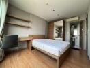 Modern bedroom with wooden flooring and a large bed