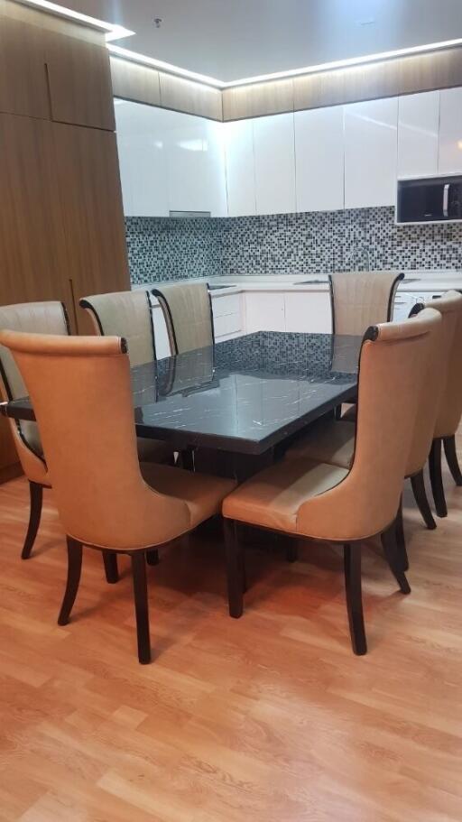 Dining area with eight-seater table and modern kitchen