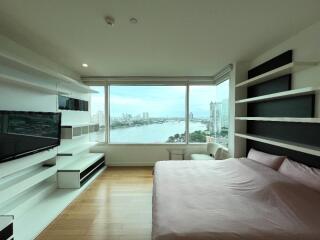 Spacious bedroom with large window and an expansive city view