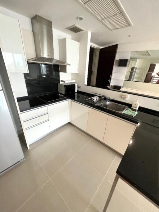 Modern kitchen with white cabinets and black countertops