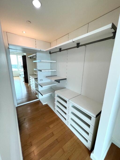 Modern walk-in closet with built-in shelving and drawers