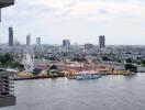 Cityscape view from a balcony showcasing waterfront and amusement park