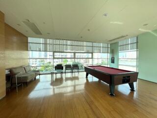 Spacious entertainment area with pool table and seating