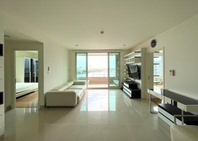 Spacious modern living room with white furniture and a view of the balcony