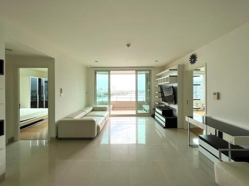 Spacious modern living room with white furniture and a view of the balcony