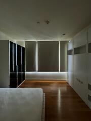 Modern bedroom with wooden floor and roller blinds