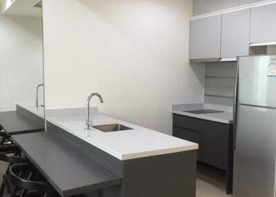 Modern kitchen with high chairs and built-in appliances