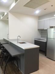 Modern kitchen with high chairs and built-in appliances