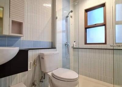 Modern bathroom with glass shower and window