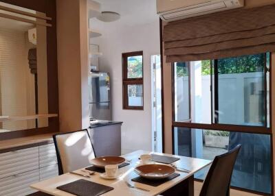 Modern dining area with table setup and natural lighting