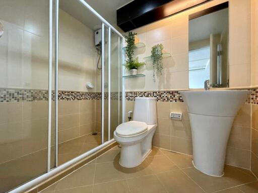 Modern bathroom with shower, toilet, and sink