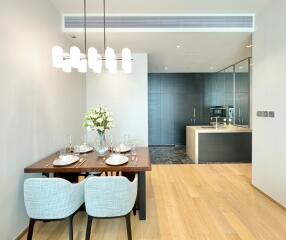 Modern dining area adjacent to a sleek kitchen