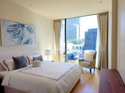 Spacious modern bedroom with large window and city view