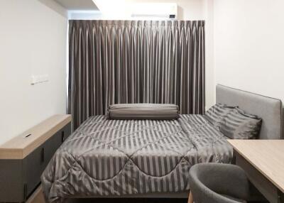Modern bedroom with grey curtains and bedding