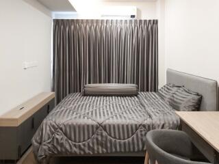 Modern bedroom with grey curtains and bedding