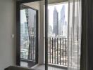 Bedroom with balcony view of city skyline