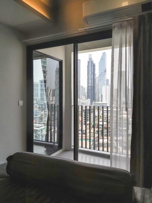 Bedroom with balcony view of city skyline