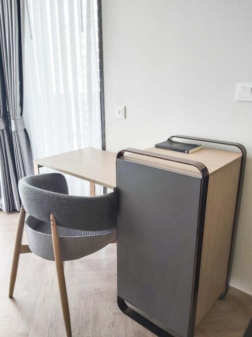 Small office setup with desk and chair near a window