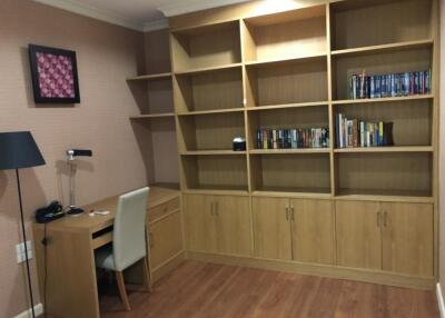 Well-organized home office with wooden bookshelves and desk