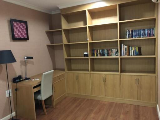 Well-organized home office with wooden bookshelves and desk