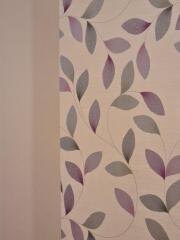 Interior wall with decorative purple and grey leaf wallpaper