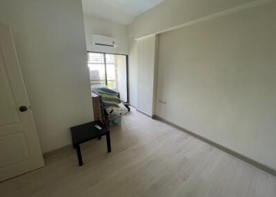 Bright bedroom with air conditioning and light wood flooring