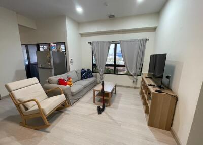 Living room with furniture including a sofa, chair, TV, and coffee table