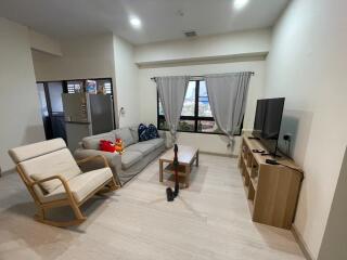 Living room with furniture including a sofa, chair, TV, and coffee table