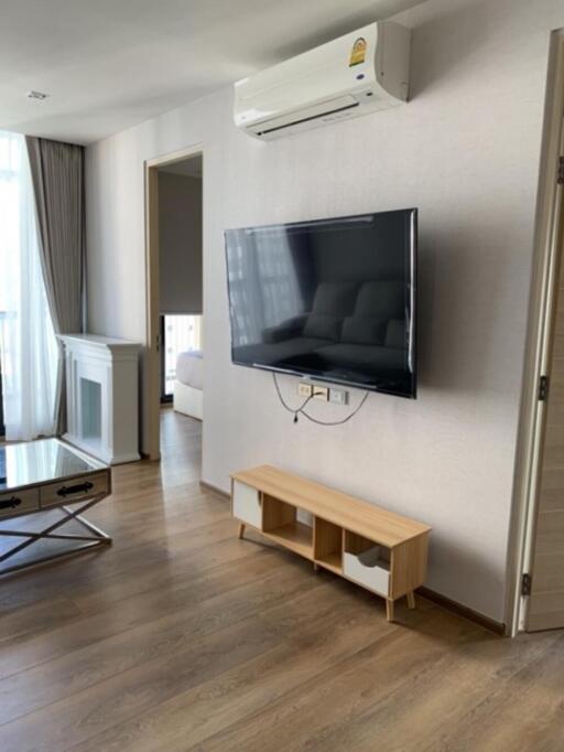 Living room with wall-mounted TV and air conditioner