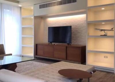 Modern living room with wall-mounted TV and built-in shelves