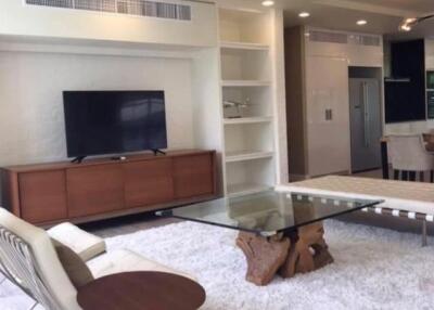 Modern living room with TV, open shelving, and contemporary furniture