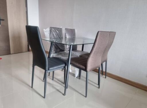 Modern dining area with glass table and four chairs