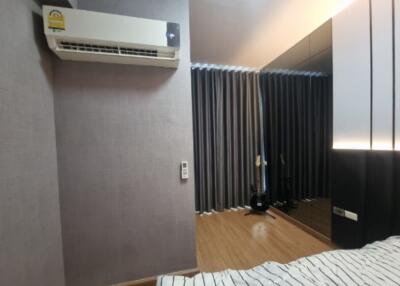 Bedroom with air conditioning and bed