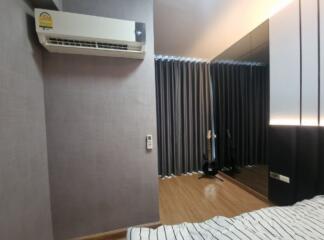 Bedroom with air conditioning and bed