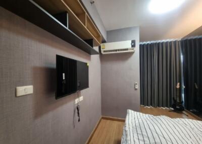 Modern bedroom with mounted TV and air conditioning