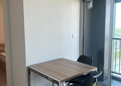 Compact dining area with a table and chairs near a balcony