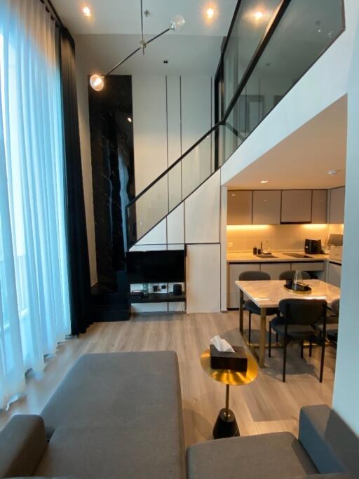 Modern living room with loft and kitchen