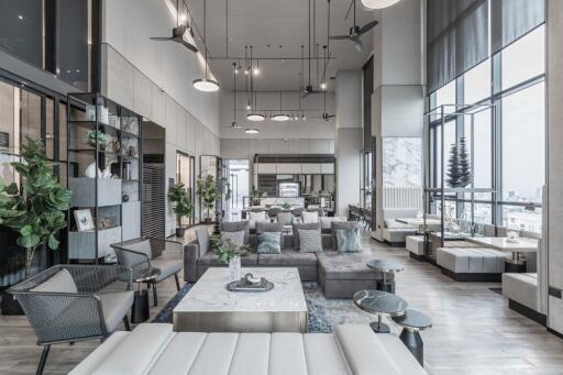 Modern, spacious living room with high ceilings and natural lighting