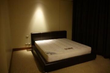 Bedroom with bed and dimmed lighting