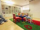 Children's playroom with colorful chairs and toy shelf