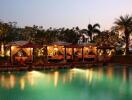 Luxurious outdoor pool area with cabanas at dusk