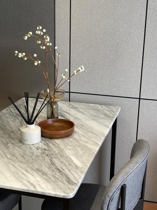 Modern kitchen table with marble surface and decorative items